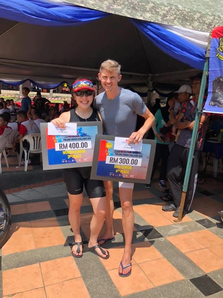 Athletes holding triathlon awards