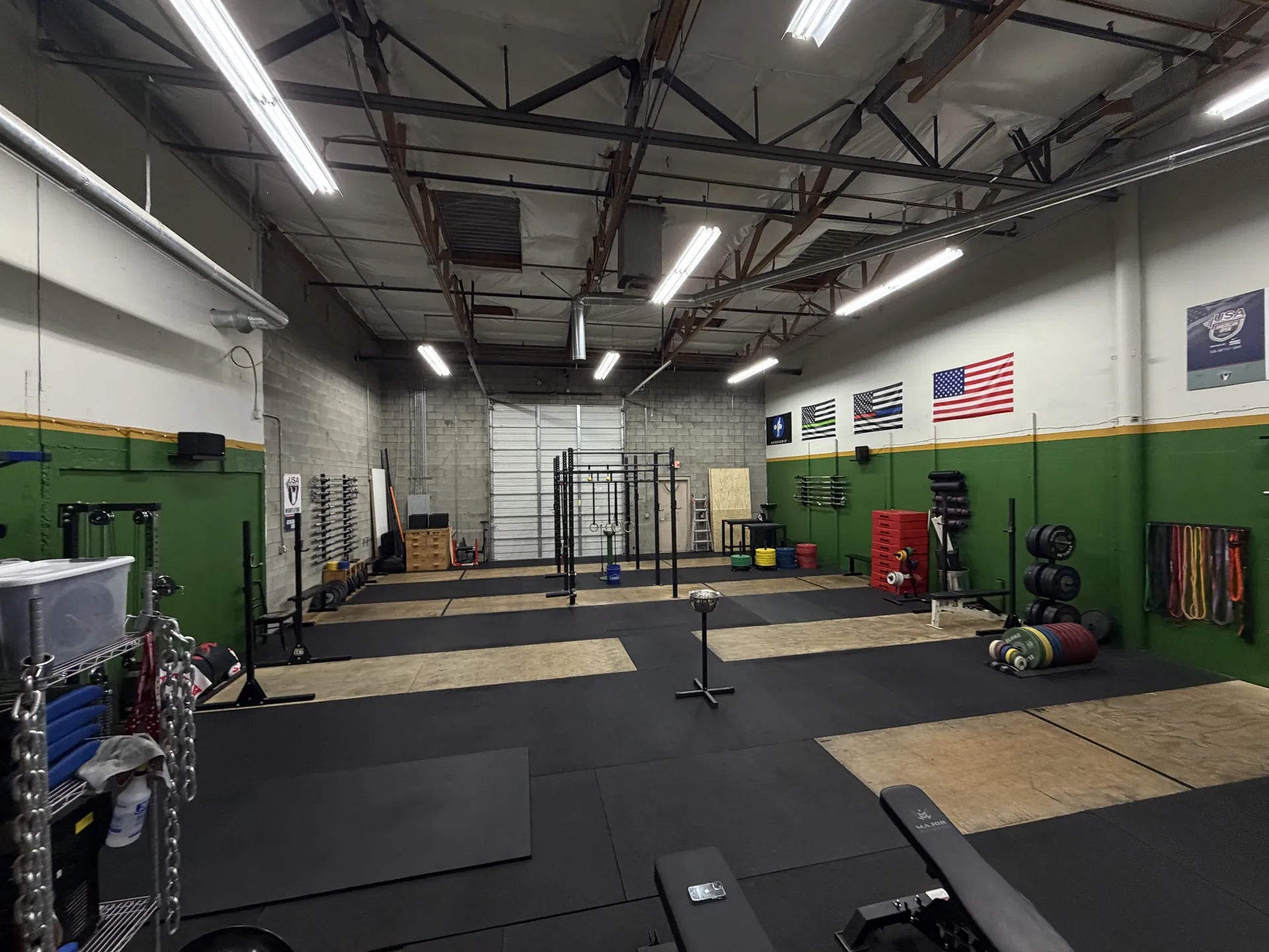 Lifting platforms and training space viewed toward the back of the gym
